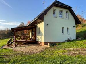 una casa blanca con una mesa de picnic delante de ella en Veselka en Dolní Bousov