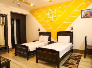 two beds in a room with a basketball mural on the wall at Pearl of Taj Home Stay in Agra