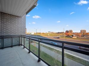 a balcony with a view of a highway at Stylish 3Br + Study Condo - Oakville in Oakville