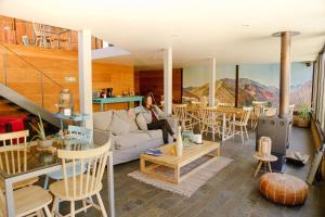 a woman sitting on a couch in a living room at Milodge Elqui Domos in Pisco Elqui