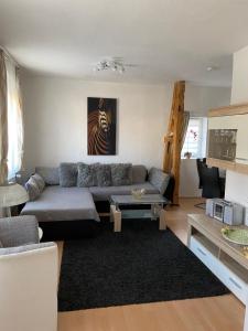 a living room with a couch and a table at Ferienhaus Gossel in Bad Wildungen