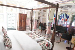 a bedroom with a bed and chairs in a room at KothiPushkar in Pushkar
