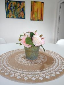 a vase filled with pink flowers sitting on a table at Brisa de Patagonia 1 in Trevelin