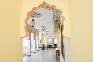 a hallway of a building with an archway and a room at KothiPushkar in Pushkar