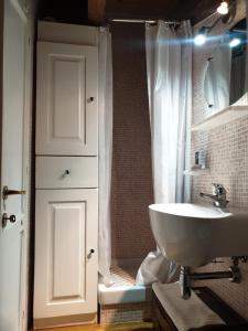 a bathroom with a sink and a shower at La Loggia Luxury in Rocca di Mezzo