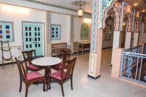 a dining room with a table and chairs at KothiPushkar in Pushkar