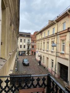 a view from a balcony of a street with a car at Old town apartment in Kaunas