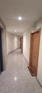 an empty room with a hallway with a door at Piso Estación Termal II in Ourense