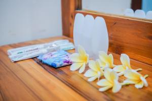 a table with two candles and flowers on it at Zamzam Anjani Villa Lombok in Praya