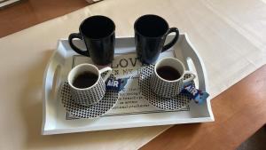 una bandeja con tres tazas de café en una mesa en 007 Apartments - Strumica, Macedonia, en Strumica