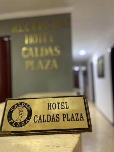 a sign for a hotel called called calidas plaza at Hotel Caldas Plaza in Caldas