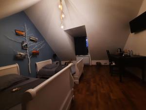 a attic room with a bed and a dining room at la longère charmante in Céaux