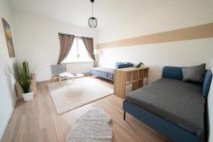 a bedroom with a bed and a desk and a couch at FULL HOUSE Studios - R85 Apartments in Zwickau