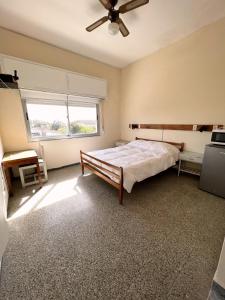 a bedroom with a bed and a ceiling fan at Edificio Casa Alba in La Paloma