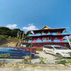 a building with cars parked in front of it at Blone Homestay by StayApart in Māngwa
