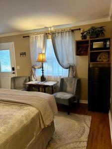 a bedroom with a bed and a chair and a desk at Grafton Lodge in Lake Lure