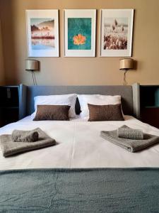 a large white bed with two pillows on it at Nature Nest - Boutique Apartment - Ravna Planina in Pale