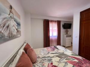 a bedroom with a bed and a television in it at Estudios Costavigía Mazagón by Ramona in Mazagón