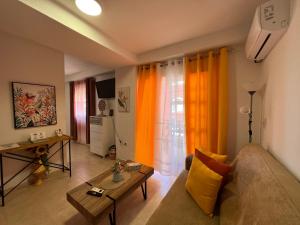 a living room with a couch and a table at Estudios Costavigía Mazagón by Ramona in Mazagón
