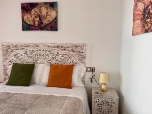 a bedroom with a bed and two paintings on the wall at Estudios Costavigía Mazagón by Ramona in Mazagón