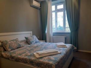 a bedroom with a bed with two towels on it at Gabala Hotel in Daşca