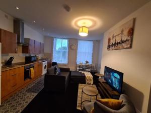 a living room with a couch and a tv in a kitchen at TimeChance Property Homz - Norton Road 1 Bed Apartment in Stockton-on-Tees