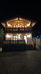 una casa con luces encima de ella por la noche en Chalet Bakuriani, en Bakuriani