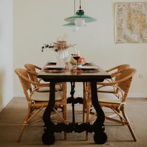 a dining room table with chairs and a vase of flowers at Apartamento Plaza de la Paz in Haro