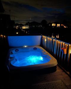a jacuzzi tub on a balcony at night at 5 Lake View, Barrow, Clitheroe - in the heart of the Ribble Valley in Pendleton