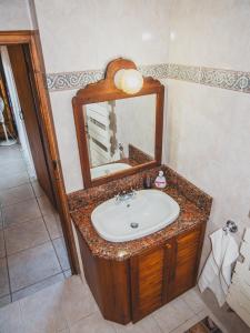 a bathroom with a sink and a mirror at Revecca House in Ayios Mamas