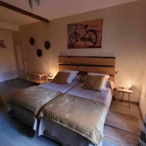 a bedroom with a bed with a bike on the wall at Au Clos du Célé in Bagnac