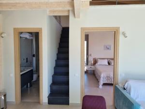 a room with a staircase and a bed and a bedroom at Villa Maya Lefkada in Évyiros