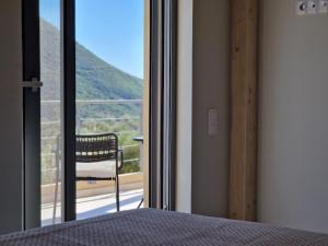 a bedroom with a bed and a window with a view at Villa Maya Lefkada in Évyiros