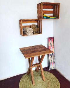 a wooden desk sitting on a rug next to a wall at Sonofjohnhomestay in Karatu
