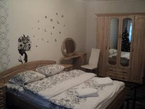 a bedroom with a bed and a mirror at Apartment on Novaya Street 5 in Bila Tserkva