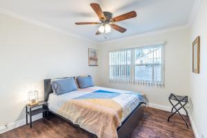 a bedroom with a bed and a ceiling fan at Spacious Home with Garden & Pool in Northridge