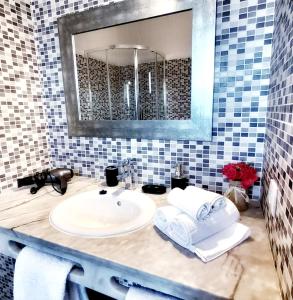 a bathroom with a sink and a mirror at Sol Brilhante in Albufeira +12 photos