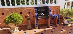 a room with a tiled wall with a fireplace at Villa Violetta in Callao Salvaje