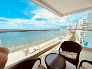 a balcony with chairs and a view of the beach at Apartamento Frenta a la Playa in Cartagena de Indias