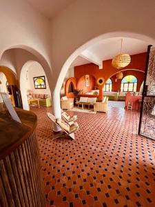 a living room with an archway and a room with couches at Villa nouran in Ghazoua