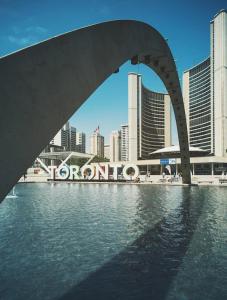 a bridge over the water in front of a city at Lovely 2 Bed Condo in Downtown Toronto in Toronto