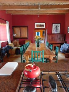 a kitchen with a table and a stove and a room at Zeekoegat Historical Homestead in Riversdale