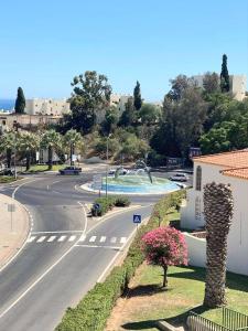 an empty street with a road with cars on it at Sol Brilhante in Albufeira