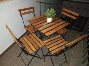 a wooden table and chairs with a potted plant on it at Alojamiento Alcantara in Alora