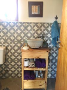 un baño con lavabo y un bol en un estante en Casa luminosa y confortable rodeada de naturaleza en San Carlos de Bariloche