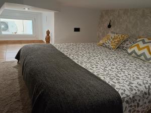 A bed or beds in a room at Budha Luxury Apartment Centro Histórico de Málaga