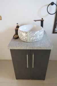 a bathroom with a bowl sink on a counter at cabañas M&V in Quellón