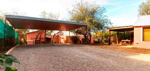 a garage with a roof on the side of a road at Mendiolaza valle del sol in Mendiolaza