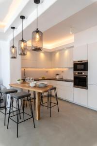 a kitchen with a wooden table and some chairs at Villa in Mykonos in Mikonos