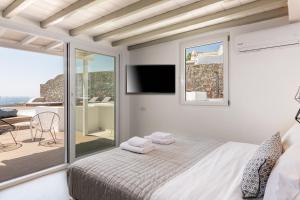 a bedroom with a bed and a sliding glass door at Villa in Mykonos in Mikonos